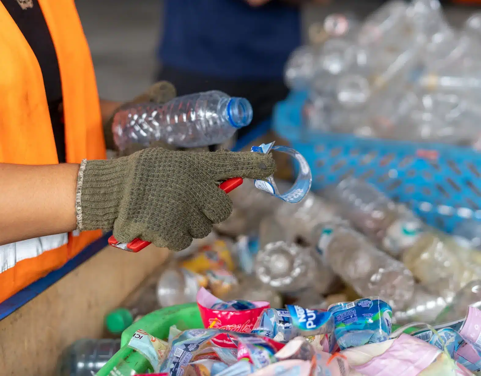 Photograph close-up of removing wrapper from plastic bottles