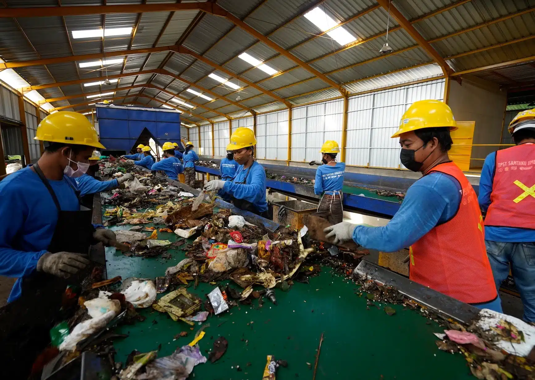 Photograph of people sorting through waste